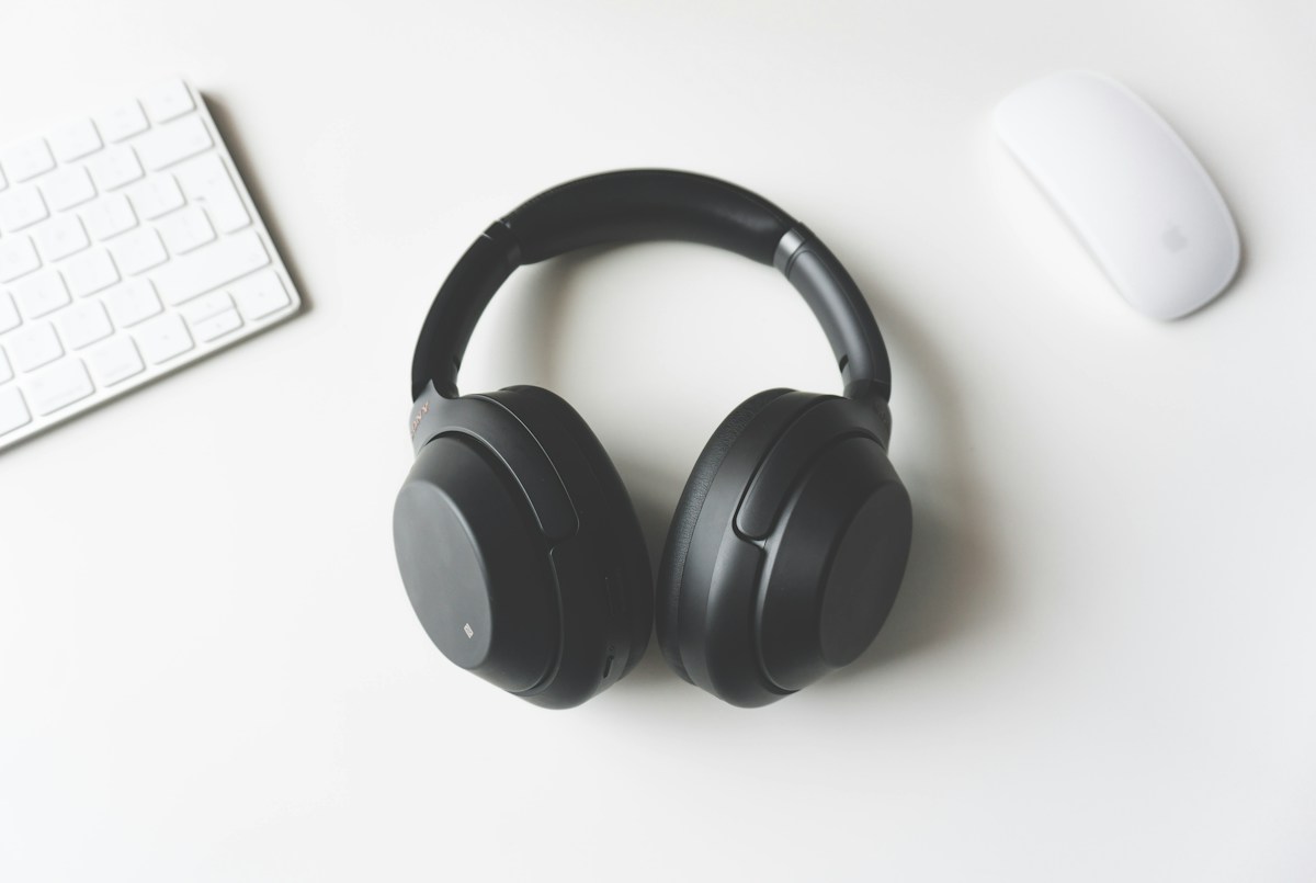 Headphones beside a keyboard and mouse