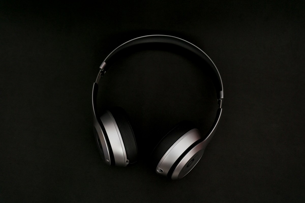 Dark over-ear headphones against a dark backdrop