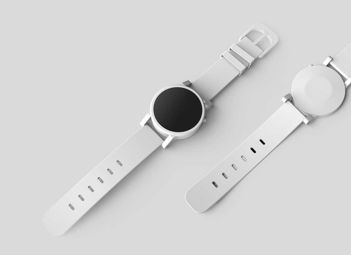 Two round smartwatches arranged on a light surface