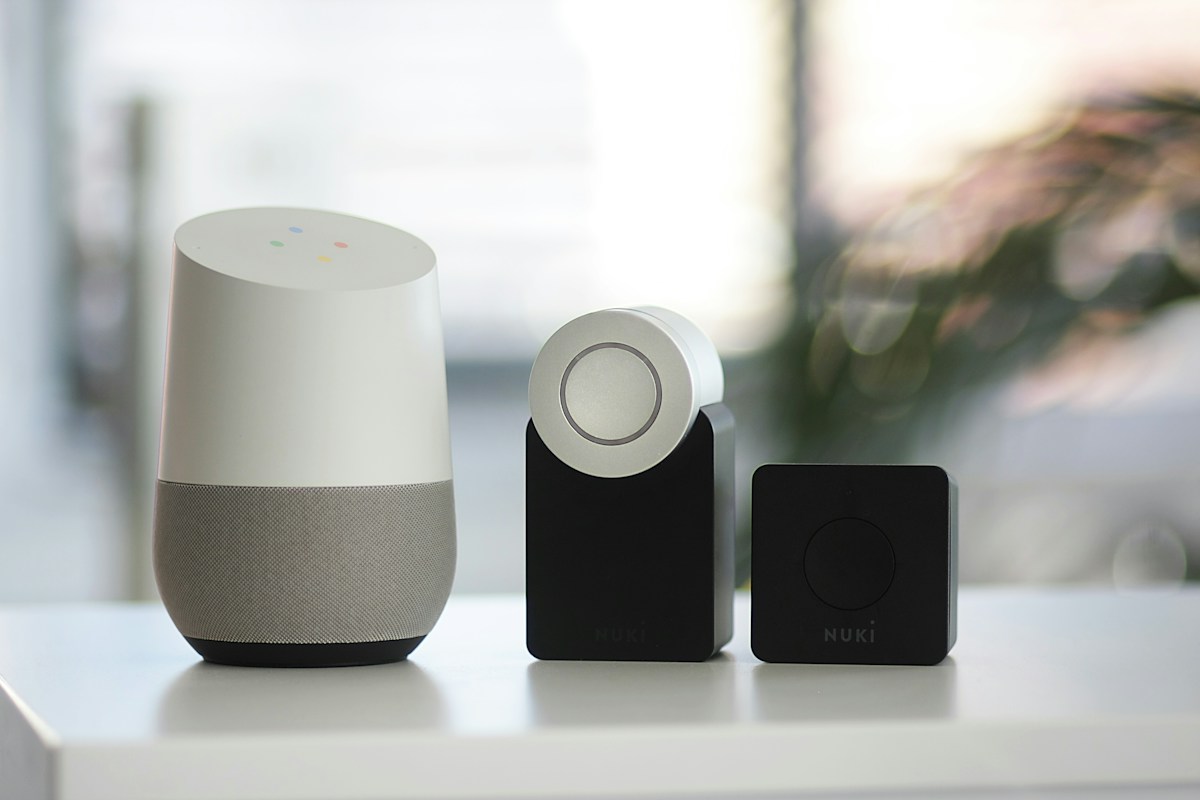 Smart speakers on a shelf near a bright window